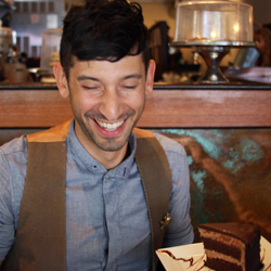 Joshua Katcher with Cafe Blossom’s vegan chocolate ganache layer cake. (Source: MRNY)