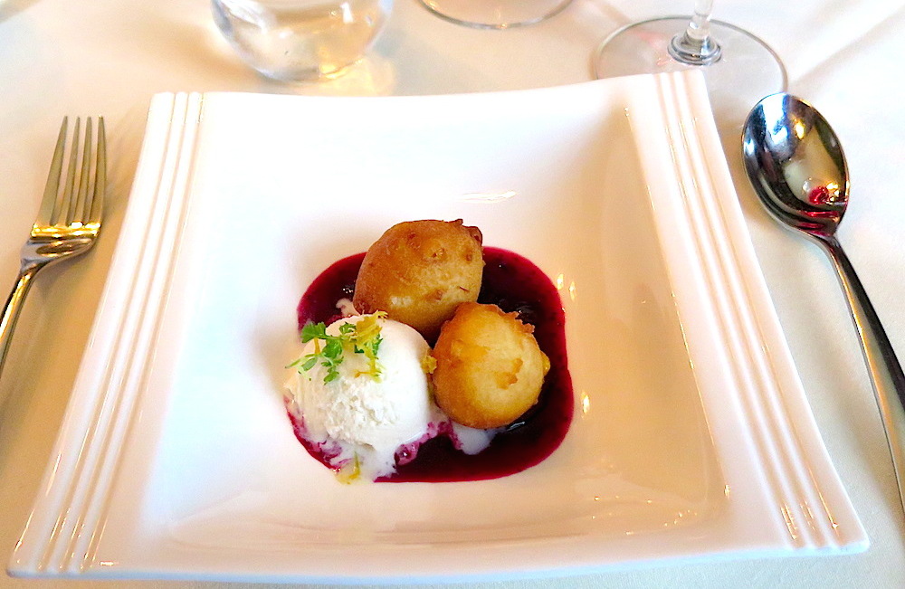 A dessert of sweet corn fritters with sour huckleberry compote and Wyoming Whiskey ice cream. © MRNY